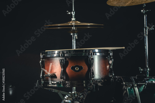 Drums on a black background close-up, percussion instrument on stage.