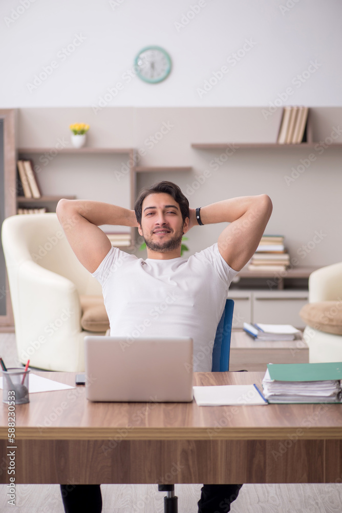 Young male employee working from home during pandemic Young male employee working from home during pandemic