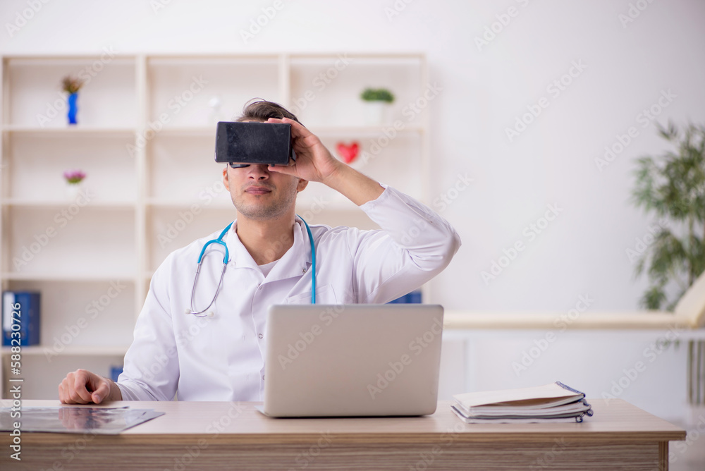 Young male doctor enjoying virtual glasses at the hospital Young male doctor enjoying virtual glasses at the hospital