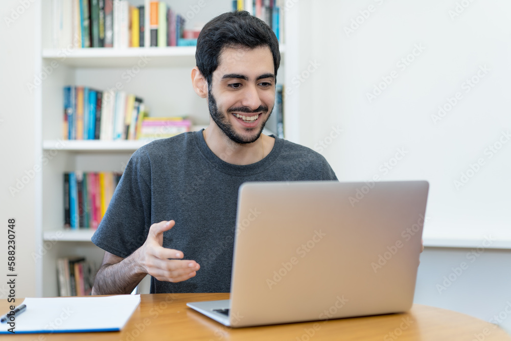 Happy israeli IT specialist at work at computer Happy israeli IT specialist at work at computer