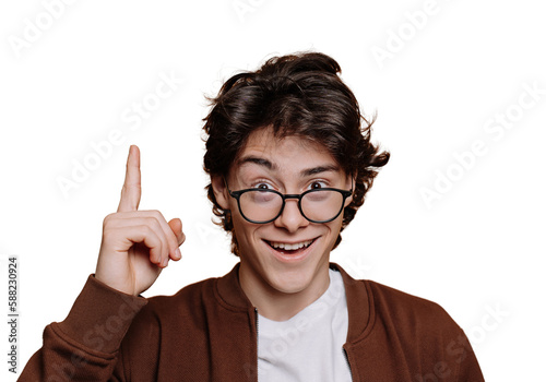 Eureka  Smart Spanish boy in white t-shirt and brown jacket pointing up by index finger at empty space on transparent background. Intelligent caucasian teenager in glasses looks at camera. Mockup.