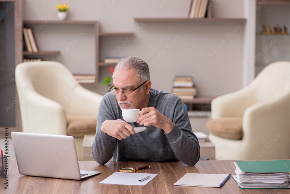 Old male employee working from home during pandemic Old male employee working from home during pandemic