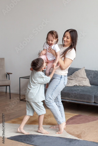 Lifestyle photo. Family time. Under celebrated moment. Children play with their mother.