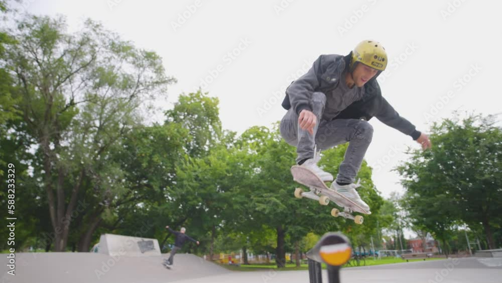 Skateboarder 180 over a bike rail in a skatepark