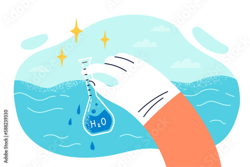 Glass flask signed H2O with water from ocean in hand environmentalist checking liquid