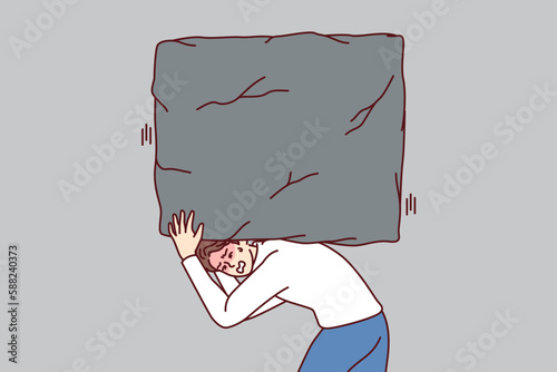 Suffering man carries heavy stone on back, symbolizing heavy tax burden and overly ambitious task. Concept of solving business problems and complexity of working as manager in large corporation 