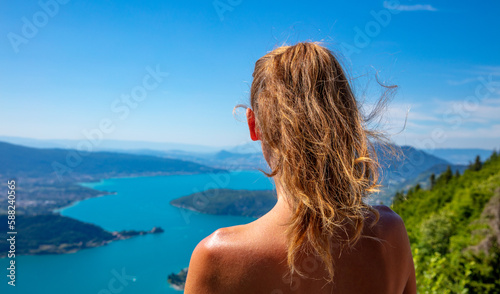 Woman looking at panoramic view of Annecy lake in France © M.studio