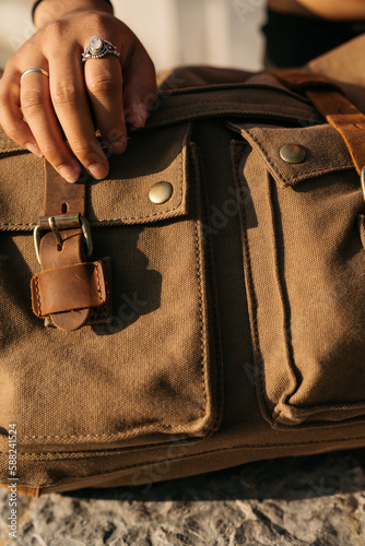 hand with rings on travellers bag