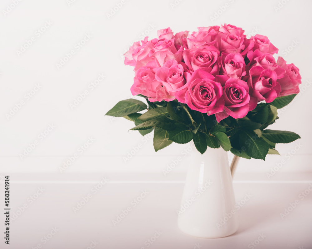 Beautiful bunch of fresh pink roses in full bloom against white background. Bouquet of flowers. Copy space for text. Valentine's day or Mother's day card.