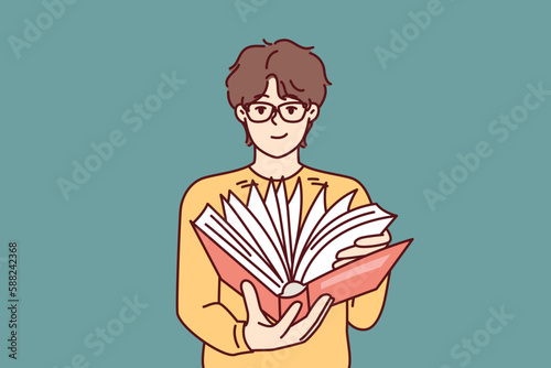 Guy student leafing through book in search information for preparation of essay given by university teacher. Man with book reads for self-education and gaining new knowledge from classical literature