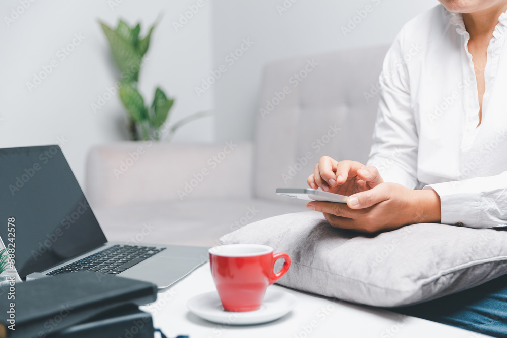 Social media day concept. Female freelancer starting working day early in living room for website with smartphone. Businesswoman working in home office. Woman communicating with online technology. Social media day concept. Female freelancer starting working day early in living room for website with smartphone. Businesswoman working in home office. Woman communicating with online technology.