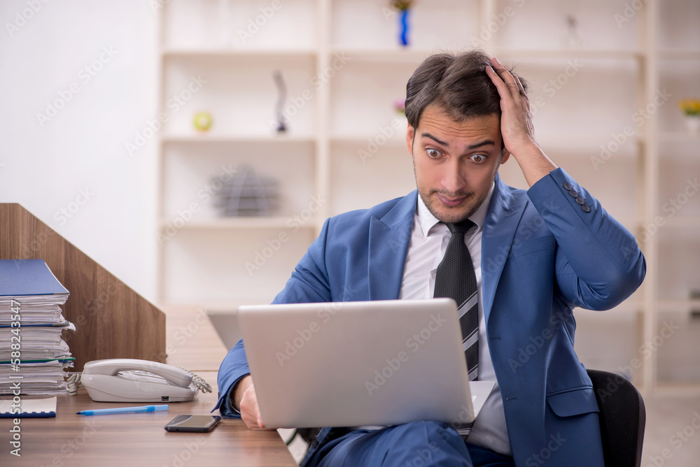 Young male employee working in the office Young male employee working in the office