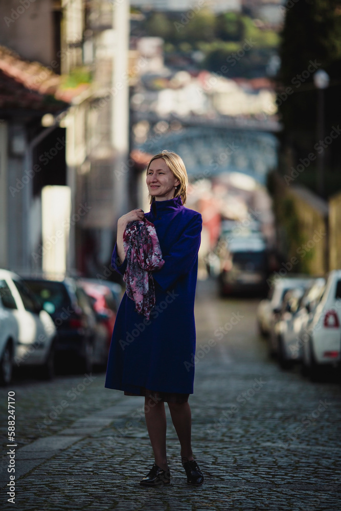 A woman walks on the street in Porto, Portugal.