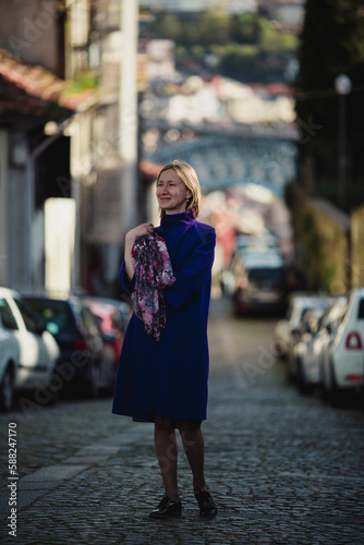 A woman walks on the street in Porto, Portugal.