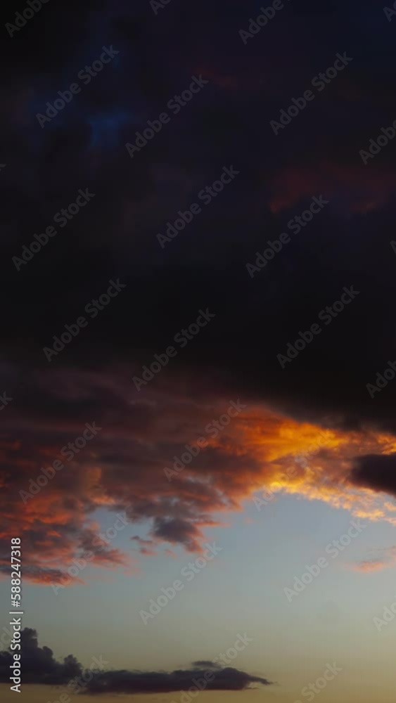 Timelapse with dramatic red sunset on dark cloudy sky. Vertical video Timelapse with dramatic red sunset on dark cloudy sky. Vertical video