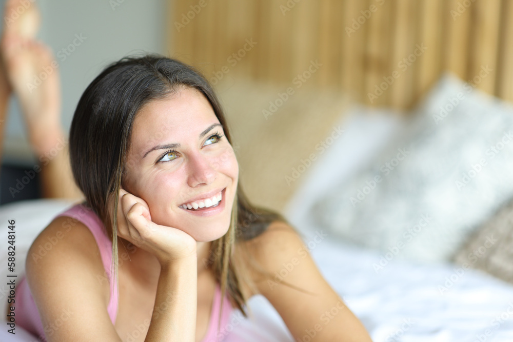 Happy teen thinking and looking at side Happy teen thinking and looking at side