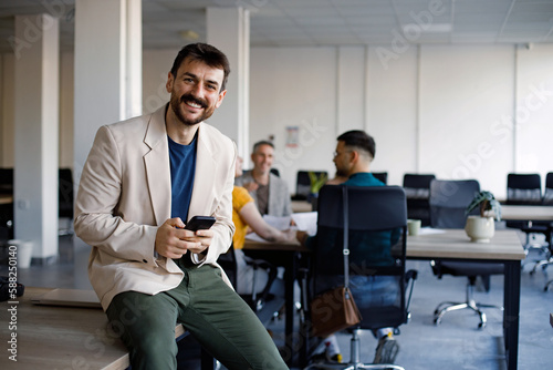 Business man reading a message on a mobile phone in an office
