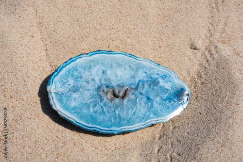 Obraz na płótnie Blue agate stone crystal on beach sand