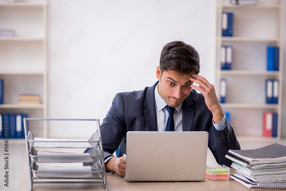 Young male employee working in the office Young male employee working in the office
