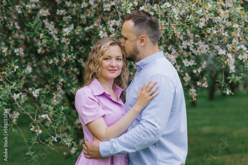 Loving man and woman on a walk in a spring blooming park