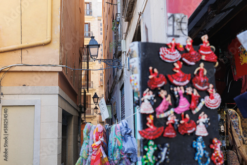 Typical Narrow Barcelona street with Old Street Lamps and Featured Souvenir Shop © GioRez