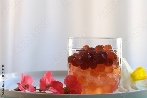 bubble tea spheres in different colors in a glass