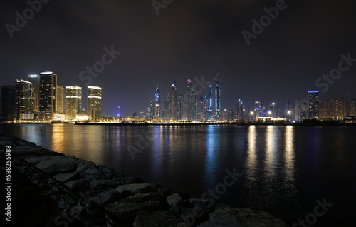 Dubai skyline by night with haze sky. Cityscape of Dubai.