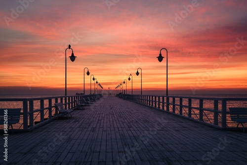 Fototapeta Naklejka Na Ścianę i Meble -  Beautiful sunrise over the Polish sea. Popular pier on the Baltic Sea at sunrise. Photo taken in Gdynia, Poland.