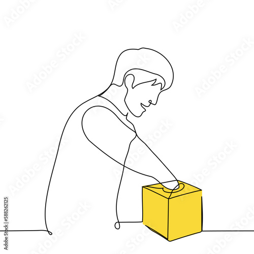 man with anticipation or joy put his hand into a small yellow box with a narrow opening - one line drawing vector. concept surprise, receiving a gift