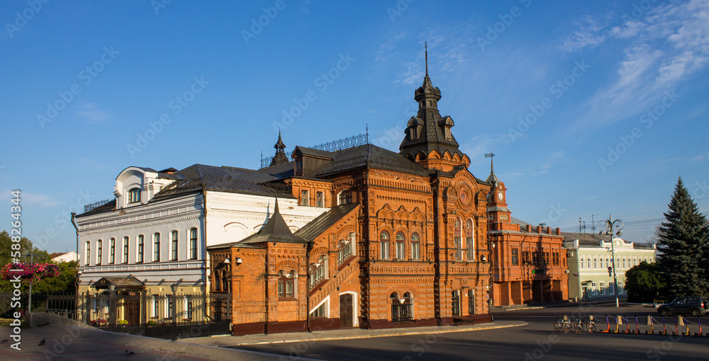 VLADIMIR, RUSSIA - AUGUST, 17, 2022: the historic brick facade of the Friendship House and the City Duma building in the old town on a sunny summer day and copy space