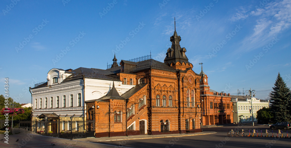 Fototapeta premium VLADIMIR, RUSSIA - AUGUST, 17, 2022: the historic brick facade of the Friendship House and the City Duma building in the old town on a sunny summer day and copy space