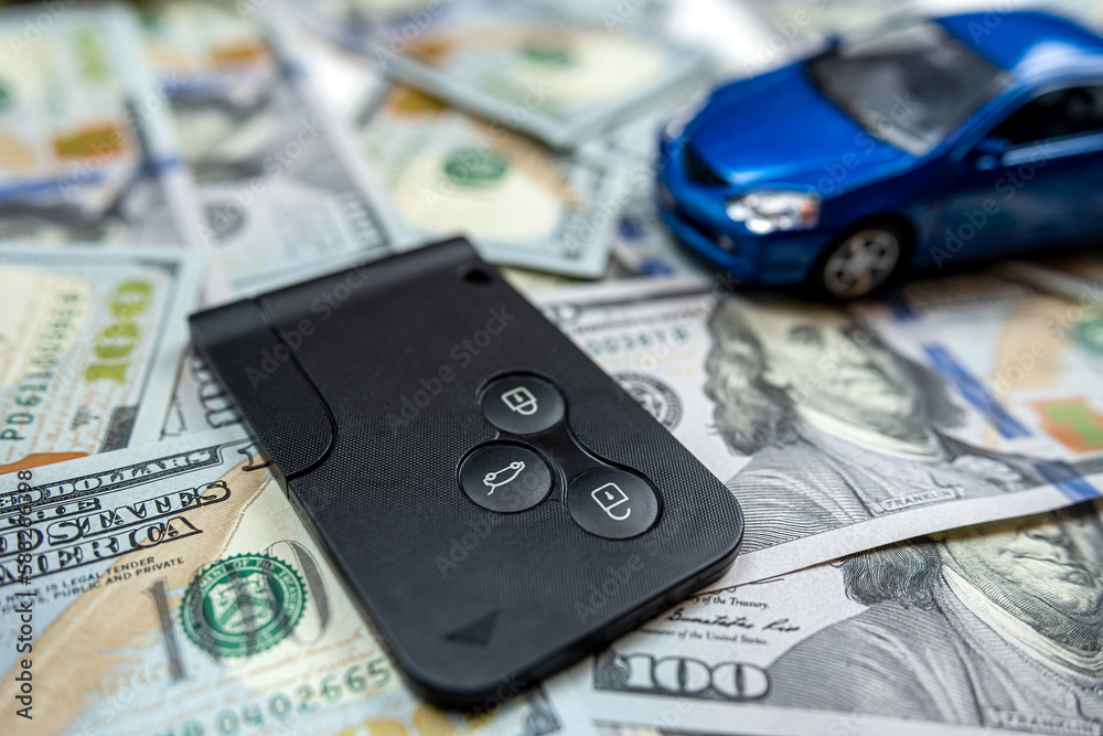 Blue samll toy car with real car keys lying dollar cash Blue samll toy car with real car keys lying dollar cash