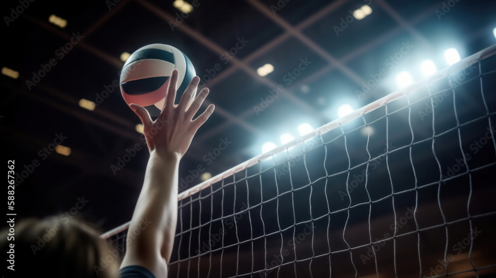Volleyball spiking and hand blocking over the net under spotlights