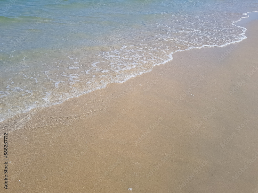 Picture of a beach with small sea waves.