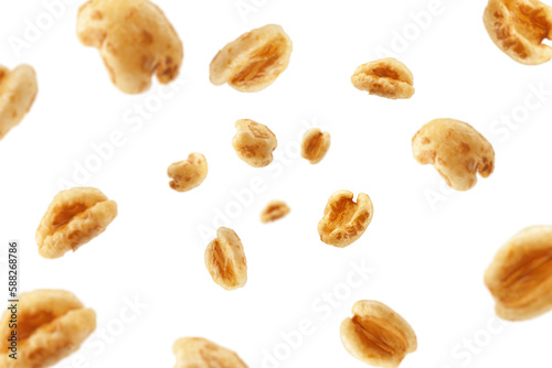 Falling puffed Wheat cereal, isolated on white background, selective focus
