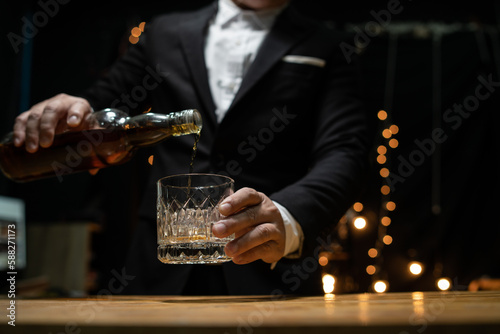 Businessman pouring whiskey victory drink