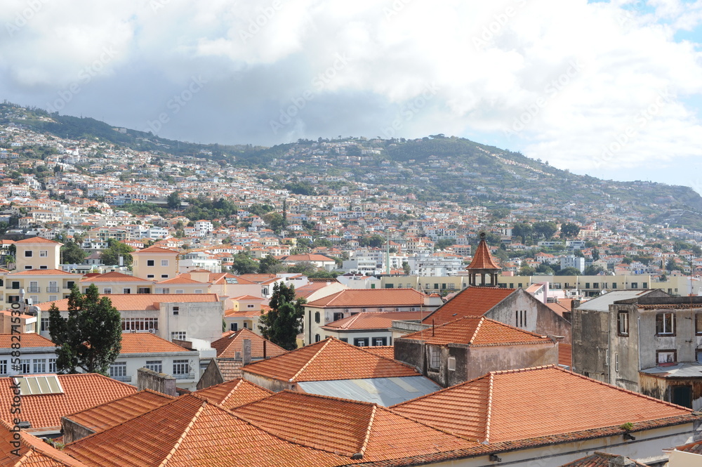 Panoramic view of the old town of Funchal, Madeira island, Portugal with red tile roofs and historical buildings