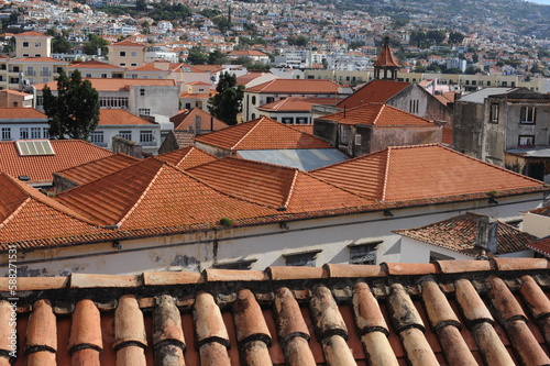 Panoramic view of the old town of Funchal, Madeira island, Portugal with red tile roofs and historical buildings