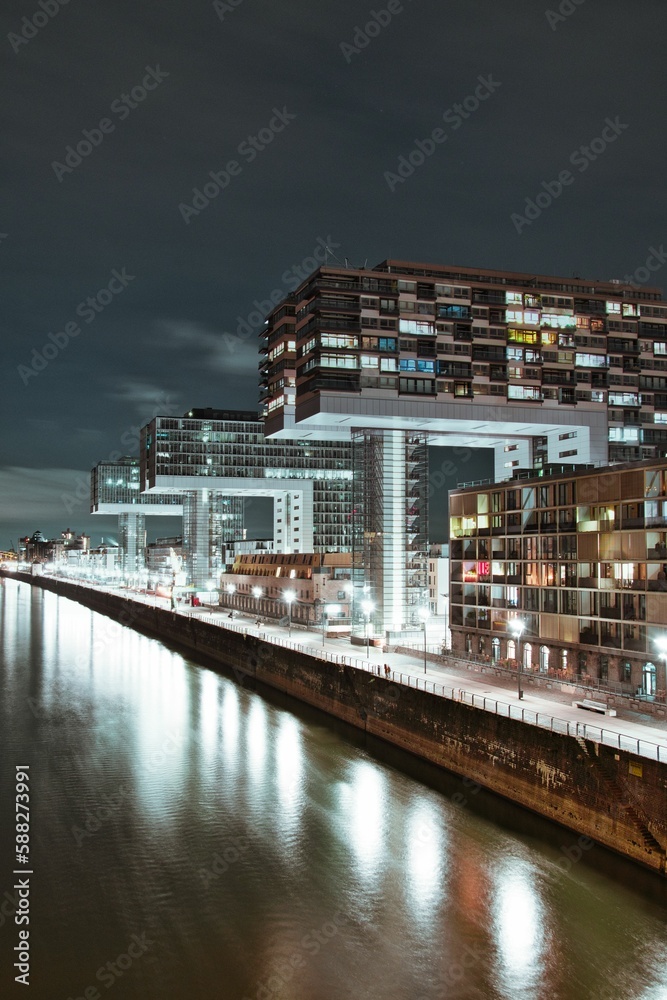Aerial view of illuminated crane houses by the canal at the Zollhafen in Cologne, Germany at night