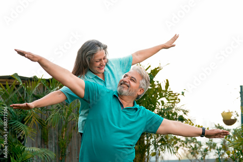 Happy Old couple spreading hand and spending time together.