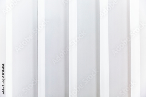 White slatted plastic wall panel. Modern trends in interior design. Space for text.