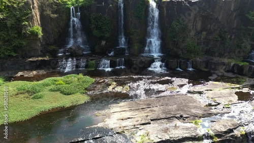 Aerial drone footage at the spectacular Pongour waterfalls in south Vietnam, Lam Dong province. Camera is moving backwards showing all the site photo