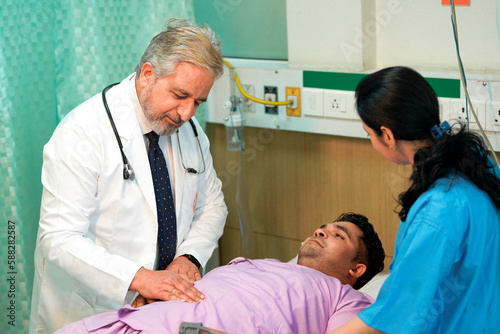 Senior Doctor check up to patient on bed at hospital.