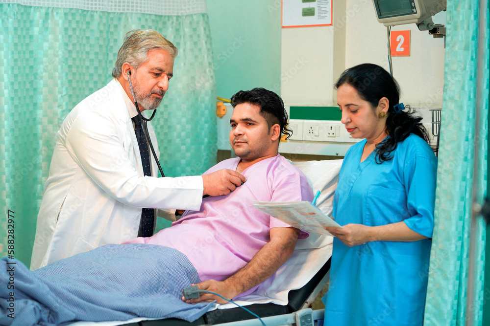 Senior Doctor check up using a stethoscope to patient on bed at hospital. Senior Doctor check up using a stethoscope to patient on bed at hospital.