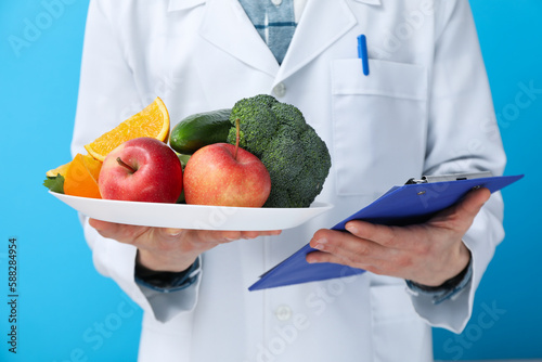 Doctor with healthy food and clipboard - healthy nutrition concept photo