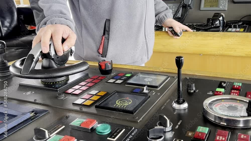 Male ship captain operating the controls to navigate
