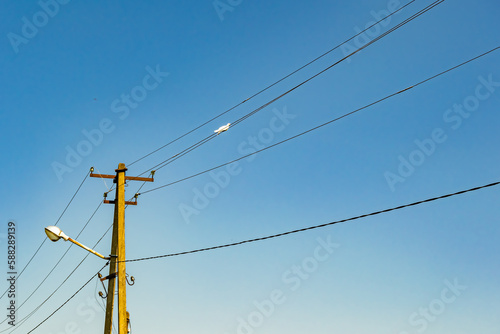 Power electric pole with line wire on colored background close up