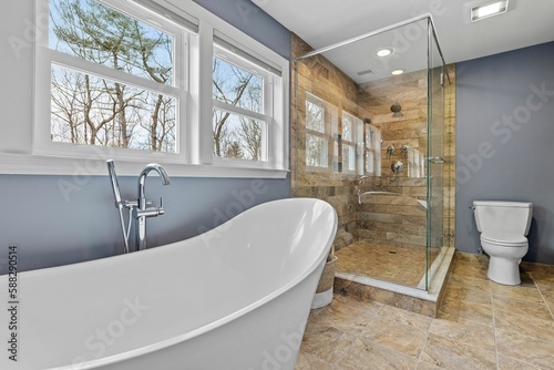 a bathroom with grey walls and brown tile floors and a tub and shower