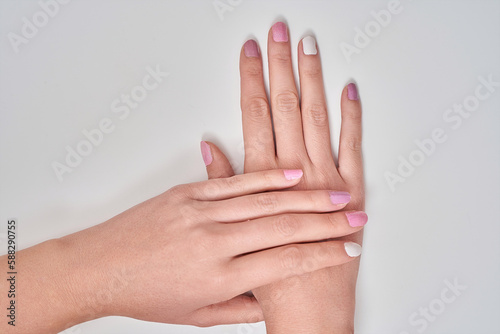 Close up view of a woman showing her hands with nail manicure. Manicure and beauty concept.