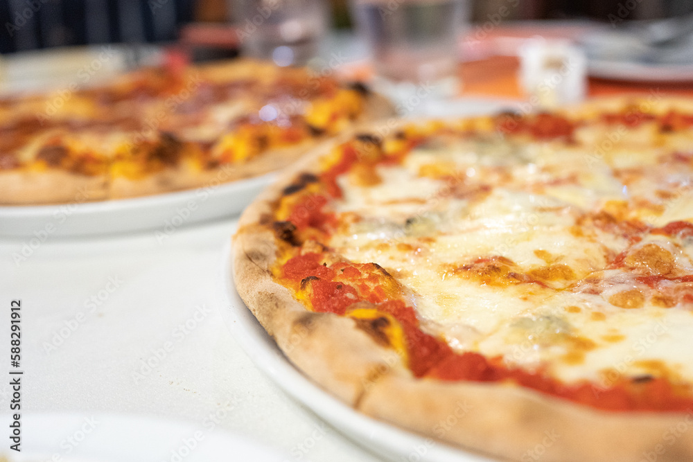 Margherita pizza or Margarita pizza on wooden background. Close up homemade fresh Italian Margherita or Margarita pizza with cheese, gourmet, basil. Pizza is traditional food for Italian on Italy. Margherita pizza or Margarita pizza on wooden background. Close up homemade fresh Italian Margherita or Margarita pizza with cheese, gourmet, basil. Pizza is traditional food for Italian on Italy.